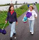 benefits of walking/two ladies walking by river